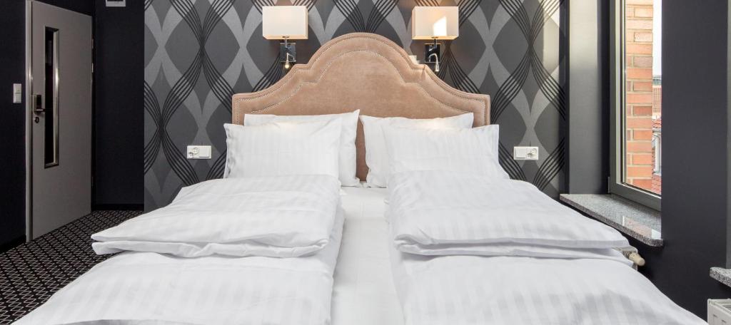 two beds with white sheets and a headboard in a room at Cocorico Bed and Breakfast OLD TOWN Szczecin Adults Only in Szczecin