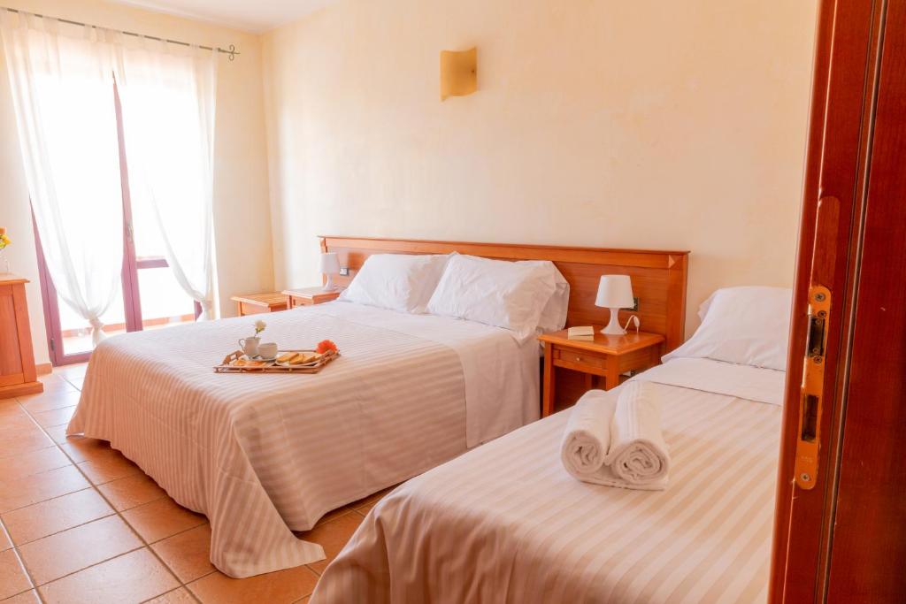 a hotel room with two beds and a tray of food at B&B Puerto Seguro in Pizzo