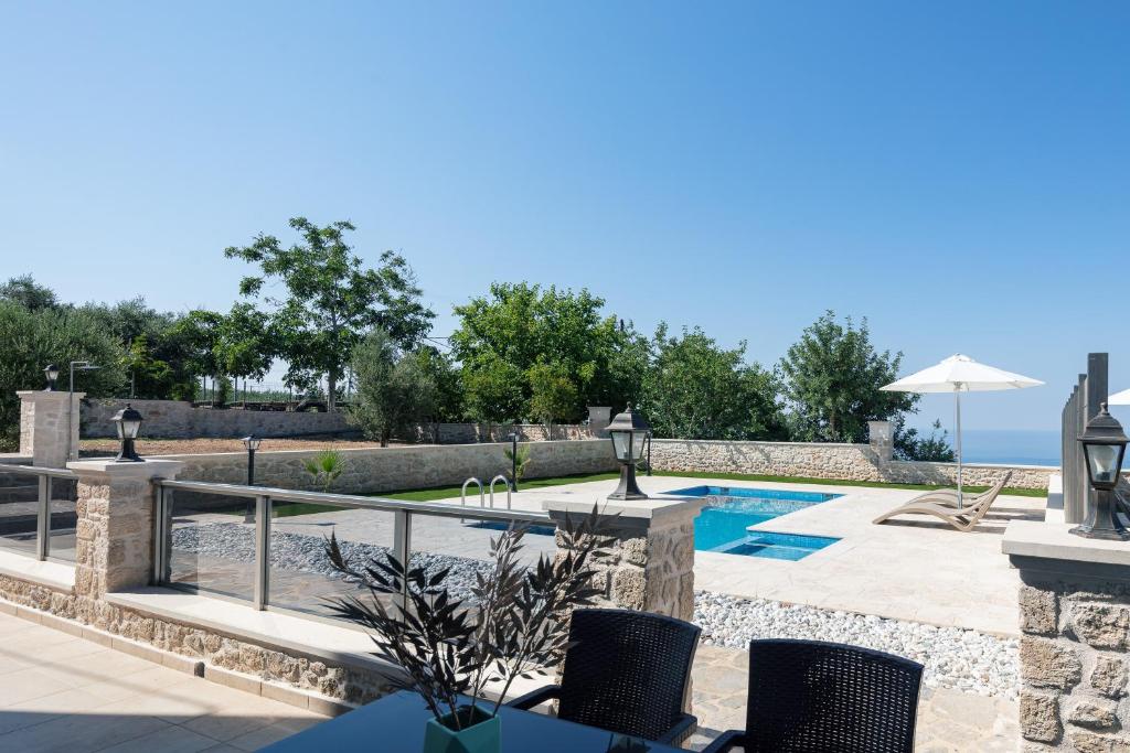 a villa with a swimming pool and a resort at Karma House in Tria Monastiria