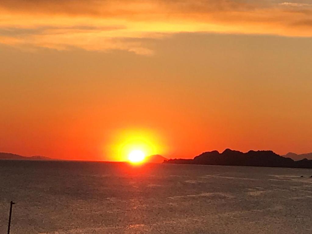 - un coucher de soleil sur l'océan et le ciel dans l'établissement Loutraki Vacation, à Loutraki