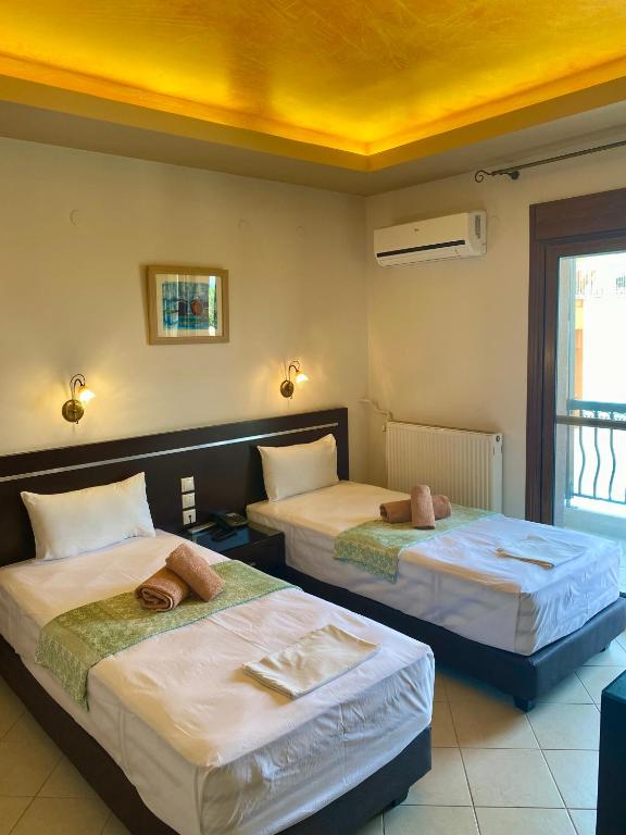 Postel nebo postele na pokoji v ubytování Hotel Alkionis
