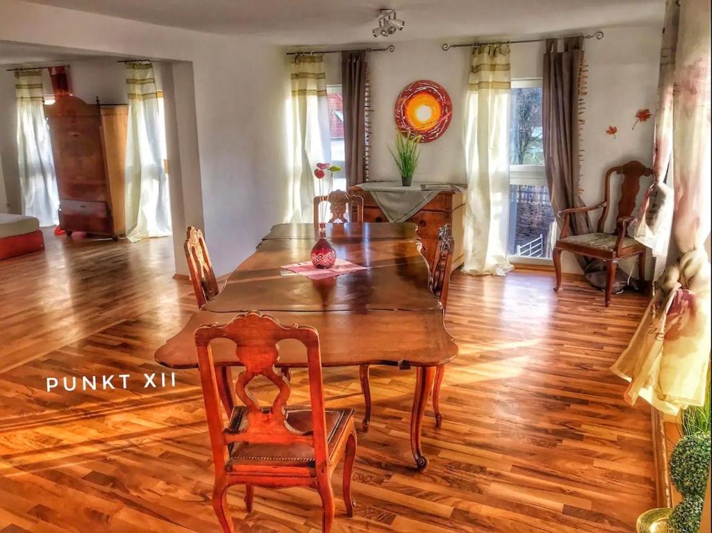 a dining room with a wooden table and chairs at Wohnung 6 und 7 in Burghaslach