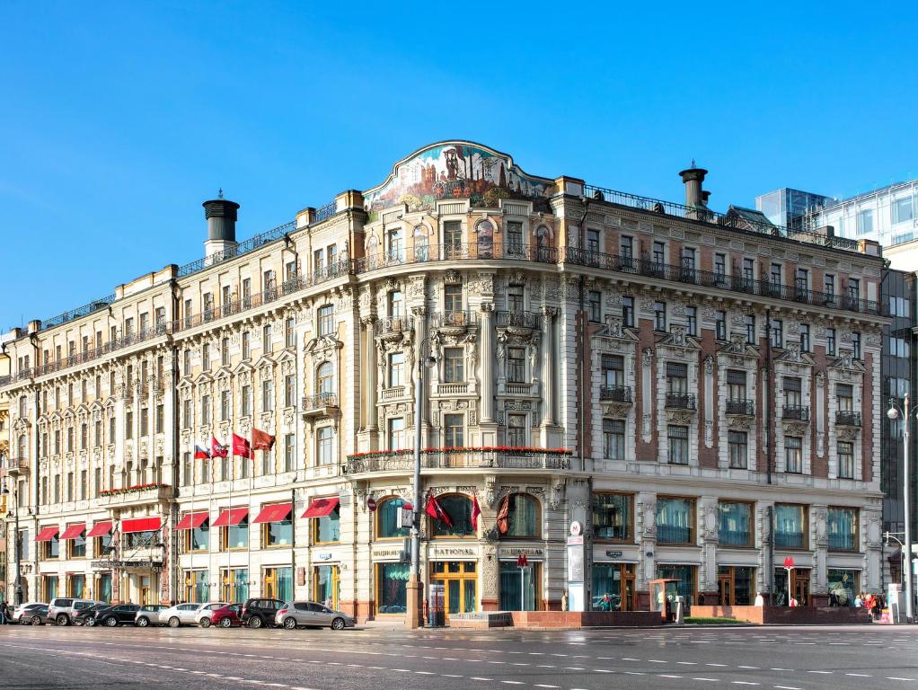 
a large building with a clock on the front of it at Hotel National, a Luxury Collection Hotel, Moscow in Moscow

