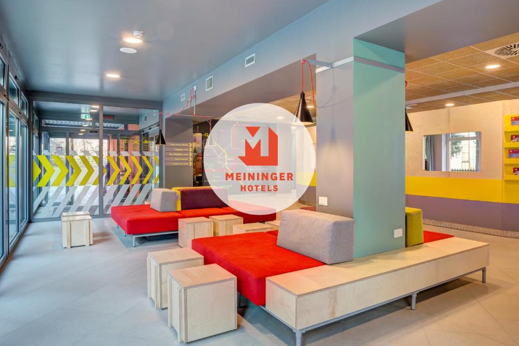 a lobby with a m member inputs sign and benches at MEININGER Milano Garibaldi in Milan