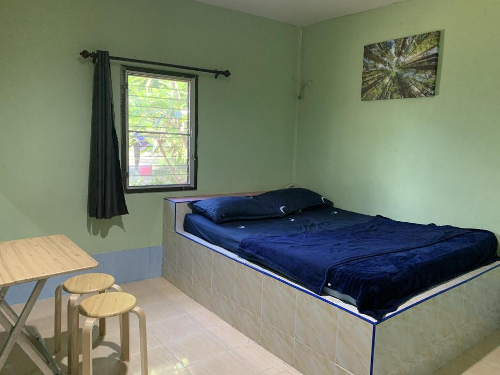 Postel nebo postele na pokoji v ubytování วังตาน้ำรีสอร์ท