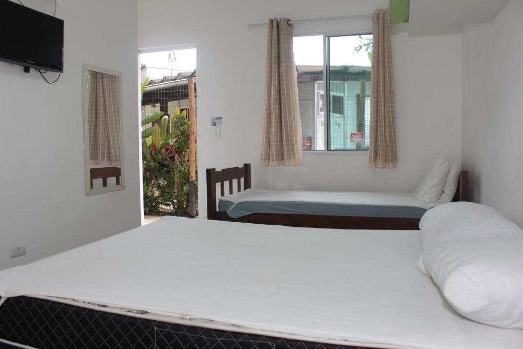 Ένα ή περισσότερα κρεβάτια σε δωμάτιο στο Pousada Nova Primavera