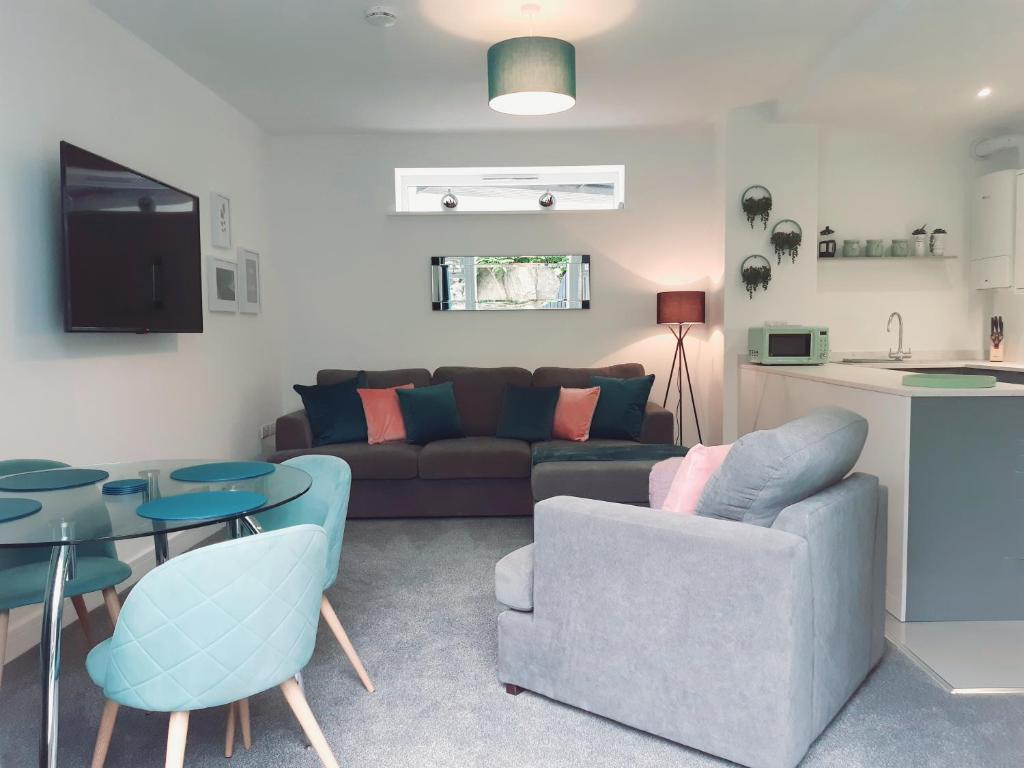 a living room with a couch and a table at No's 7 and 8 Llewelyn Apartments in Llanberis