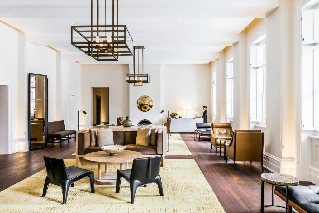 a living room with a couch and chairs at COMO The Treasury in Perth