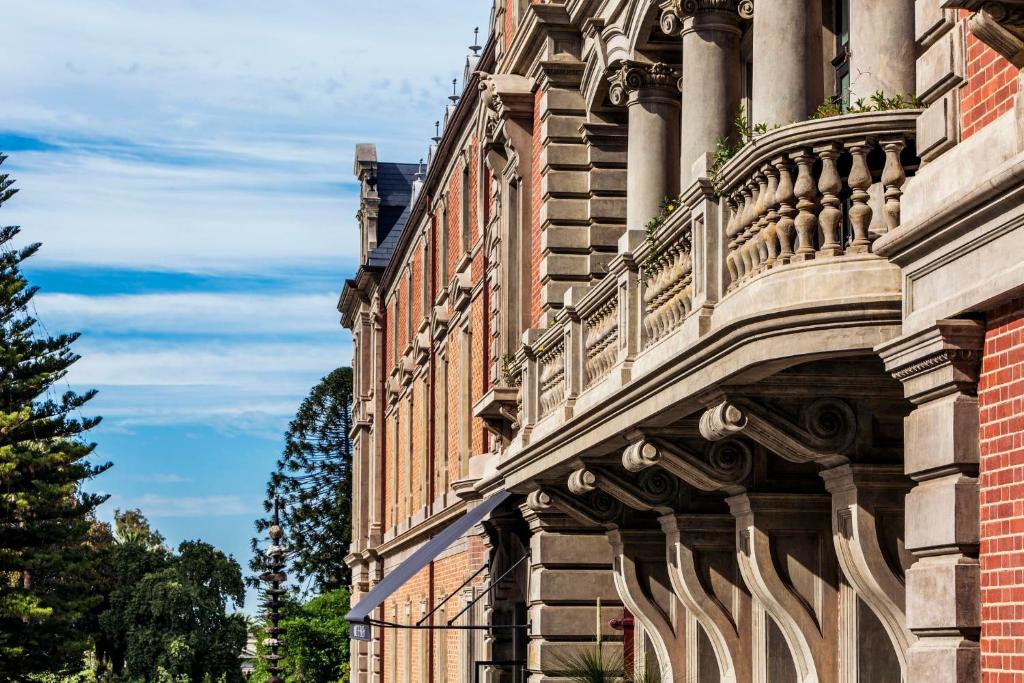 a building with a balcony on the side of it at COMO The Treasury in Perth