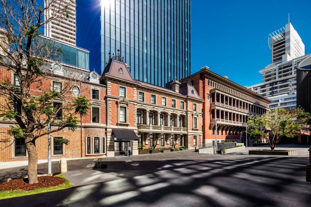 an empty street in a city with tall buildings at COMO The Treasury in Perth