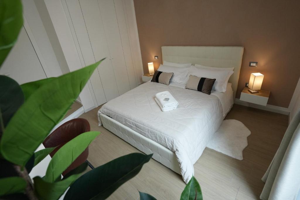 a bedroom with a bed with a phone on it at Luxury Rooms Paoli 19 in Cagliari