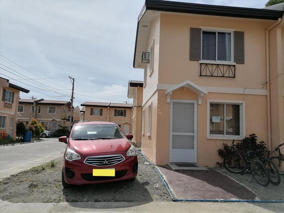 a red car parked in front of a house at Eurich Furnished Unit 2 in Butuan