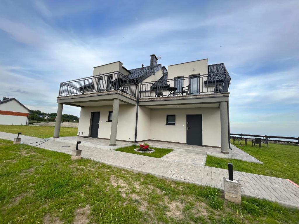 a house with a balcony on top of it at Wyspówka in Międzyzdroje