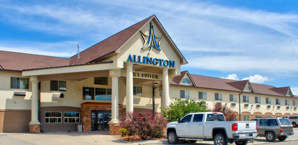 a hotel with a truck parked in front of it at Allington Inn & Suites Kremmling in Kremmling