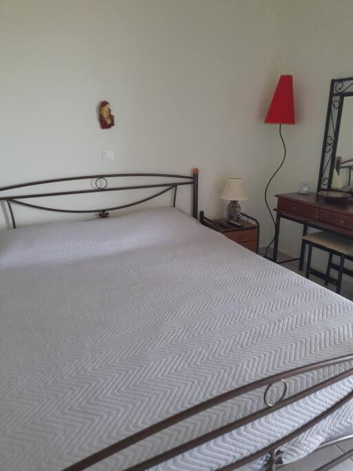 A bed or beds in a room at Derveni Summer House