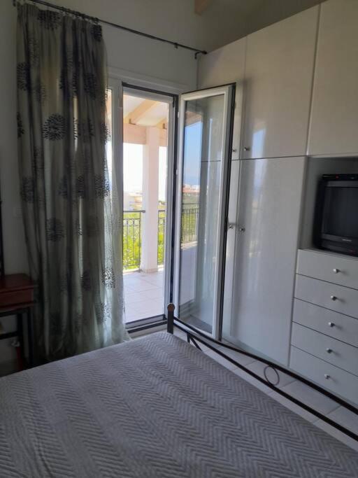 A bed or beds in a room at Derveni Summer House