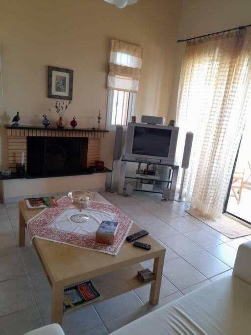 A television and/or entertainment centre at Derveni Summer House