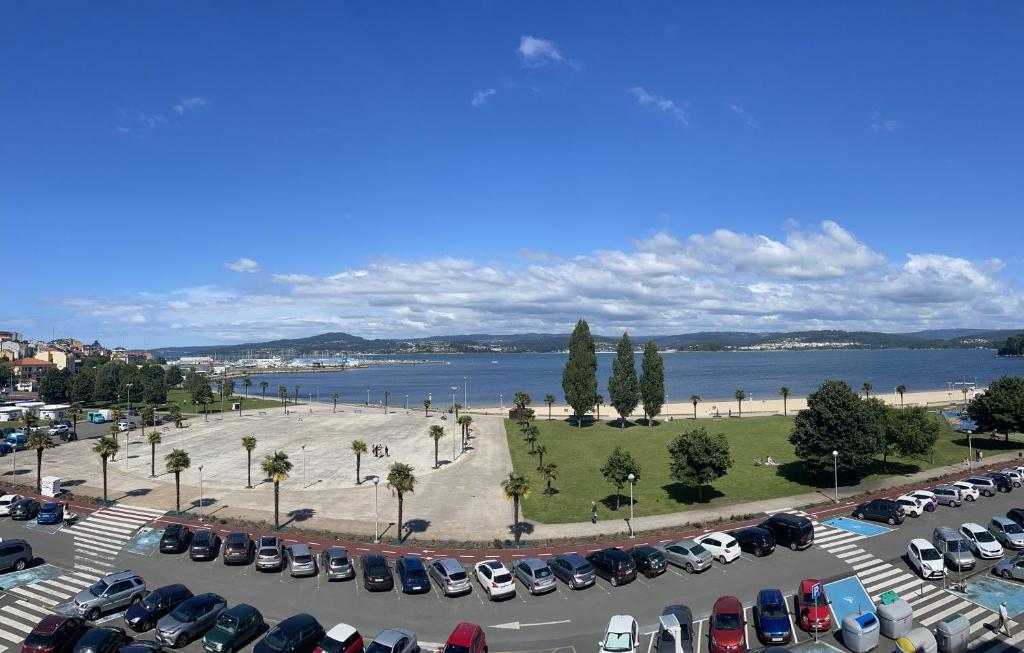 a parking lot with a lot of parked cars at Apartamento A Tenencia in Sada