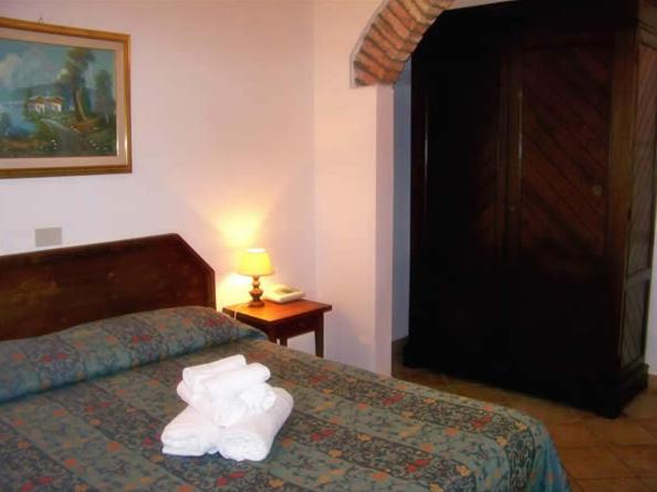 Postel nebo postele na pokoji v ubytování Hotel Residence I Briganti di Capalbio