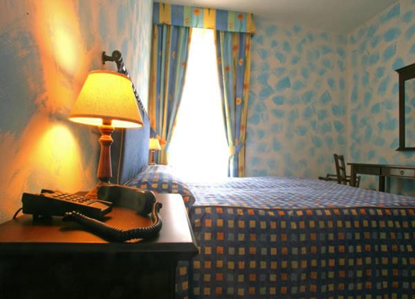 Postel nebo postele na pokoji v ubytování Hotel Residence I Briganti di Capalbio