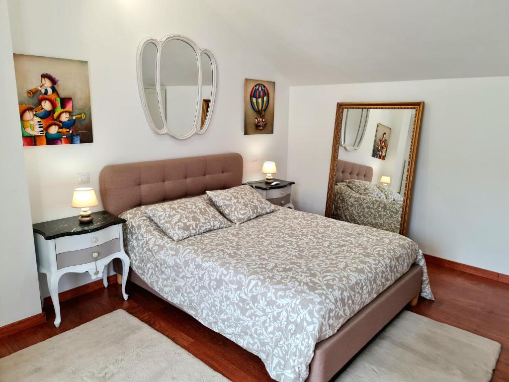 1 dormitorio con 1 cama grande y espejo en Fabuloso apartamento con terraza y piscina, en Villabáñez