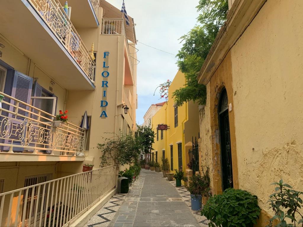 an alley in a building with a sign that reads acropolis at FLORIDA HOTEL, ADULTS only in Rhodes Town