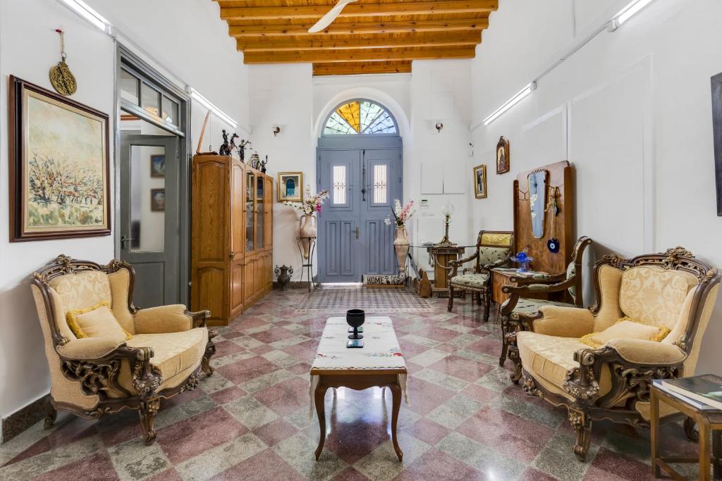 a living room with two chairs and a table at To Hani - Large Traditional House in Nicosia