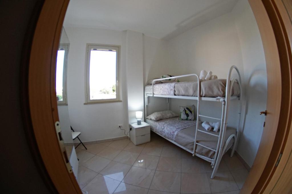 Postel nebo postele na pokoji v ubytování Holiday House Villa AleGiù Marzamemi