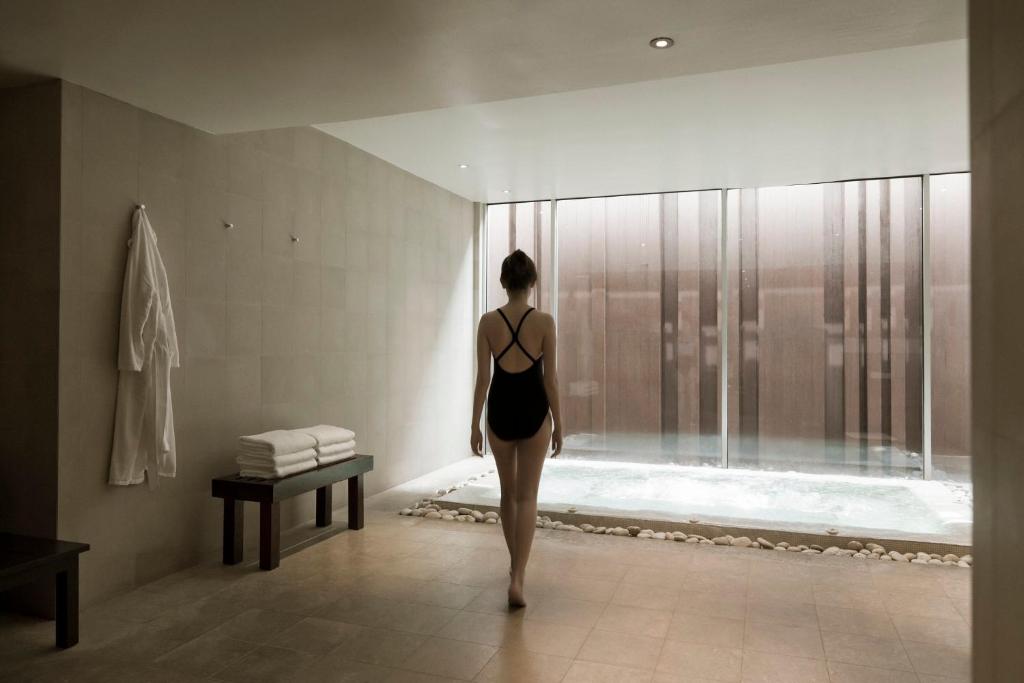 An indoor plunge pool beside a tiled relaxation area.