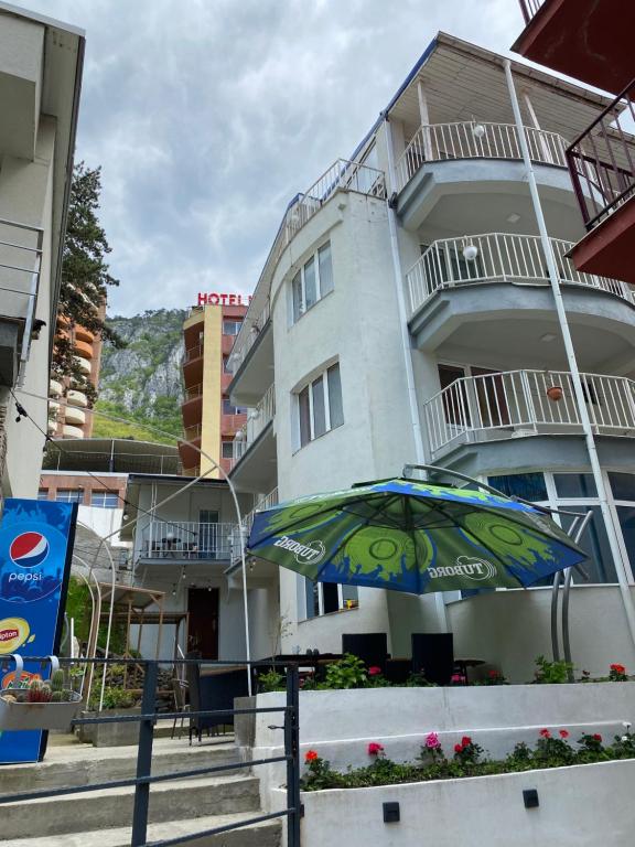 a colorful umbrella in front of a building at Pensiunea Ambasador in Băile Herculane