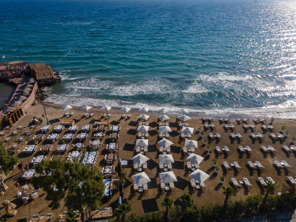 an aerial view of a beach with umbrellas and the ocean at Rammos Managed By Dedeman in Bodrum City
