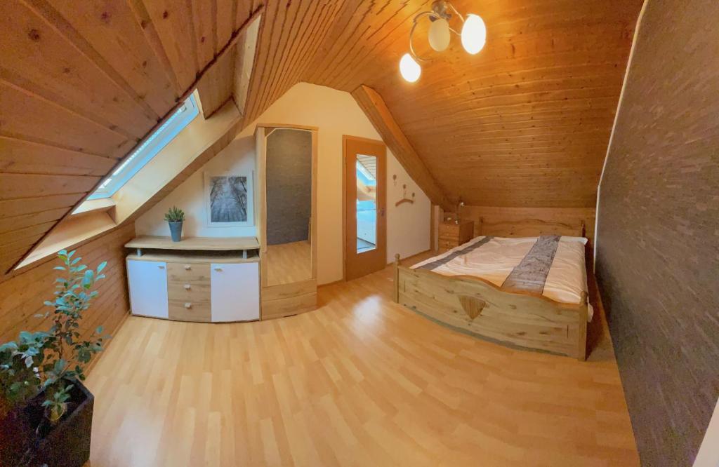 a bedroom with a bed in a wooden house at Geräumiges Maisonette Apartment in Todtmoos