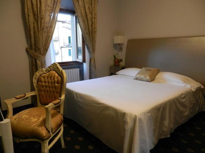 Postel nebo postele na pokoji v ubytování Sangallo Hotel