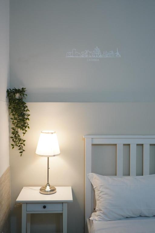 Łóżko lub łóżka w pokoju w obiekcie Magrì Apartments Catania