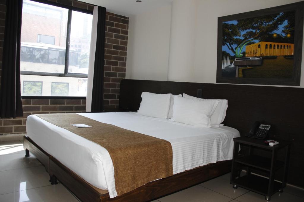 Postel nebo postele na pokoji v ubytování Hotel Acqua Medellín