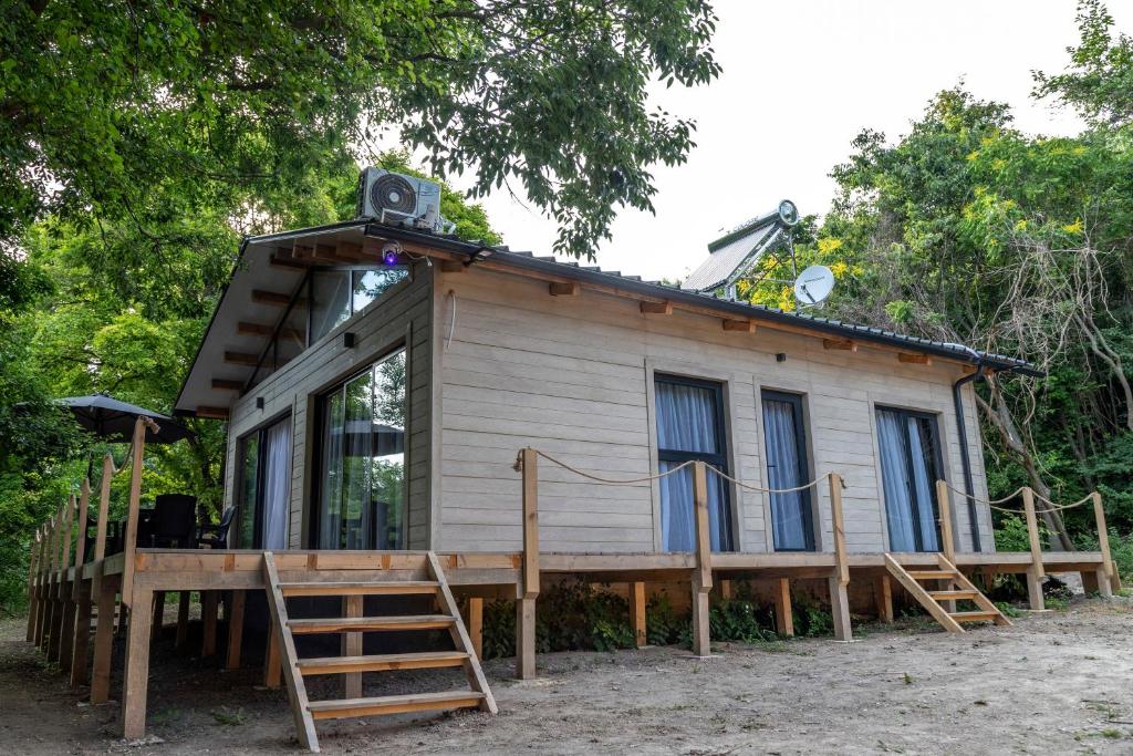 a tiny house with a porch and a deck at Ecopark Tuzlata Екопарк Тузлата in Balchik