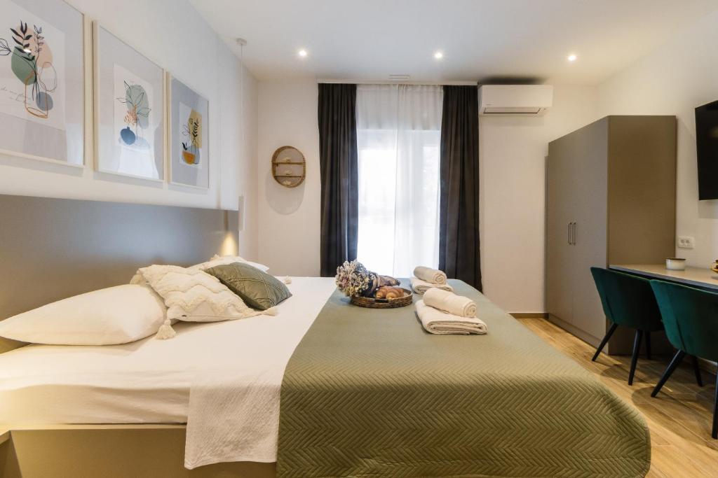 Postel nebo postele na pokoji v ubytování Apartments KIWI