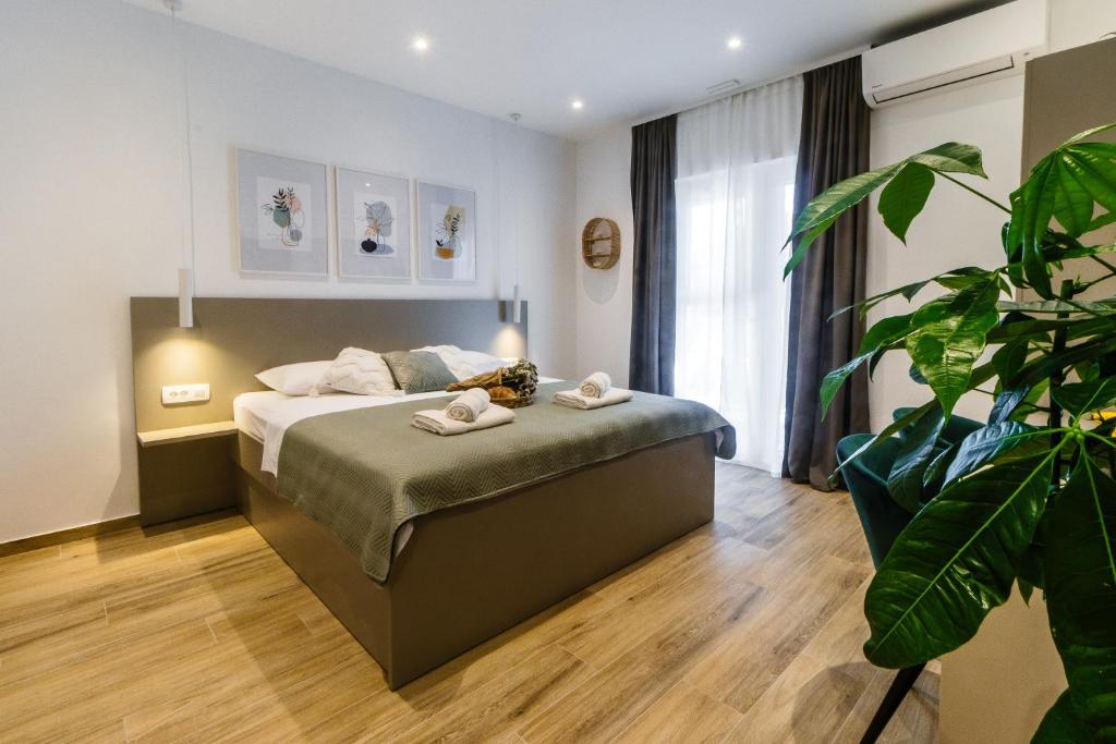 Postel nebo postele na pokoji v ubytování Apartments KIWI