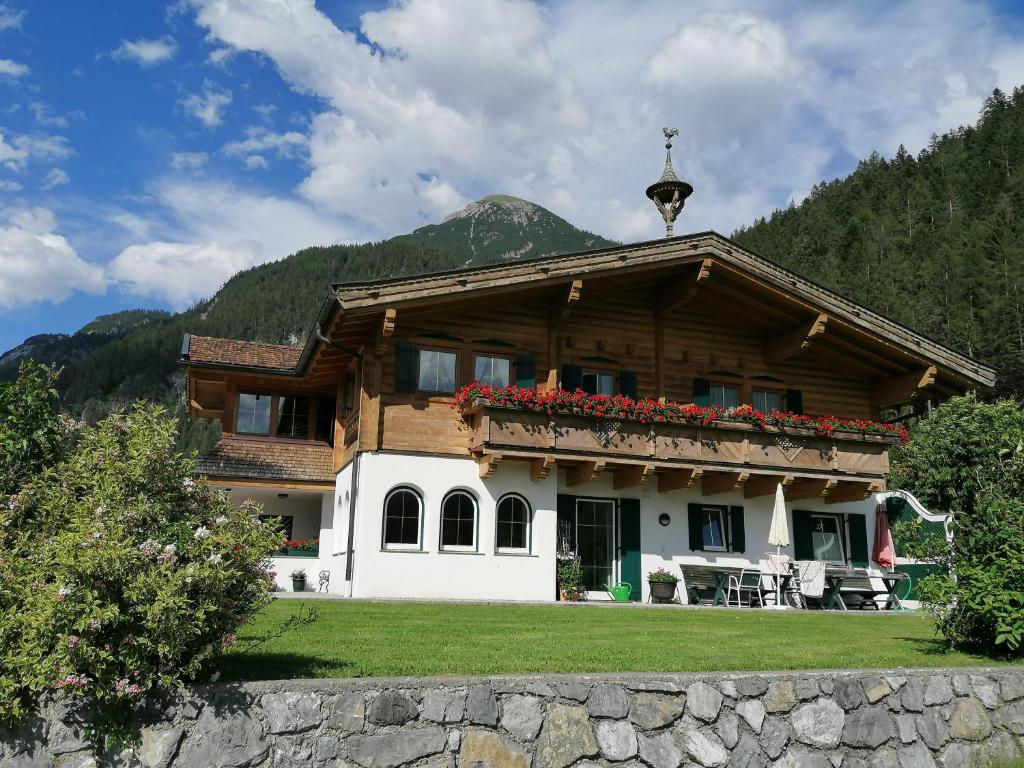 a house in the mountains with flowers on the balcony at Haus Bielefeld in Elmen