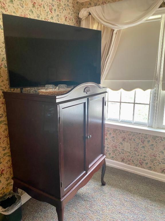 a wooden cabinet in a room with a window at The Cypress Inn in Conway