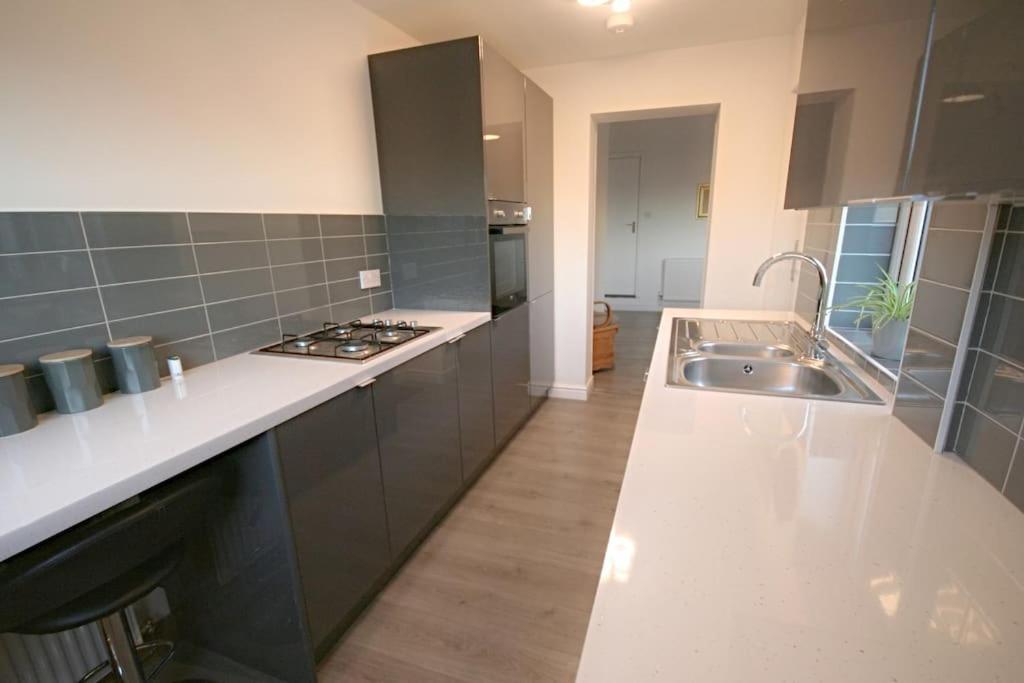 a kitchen with a sink and a counter top at Charming 3-Bed House in Whitwell village in Worksop