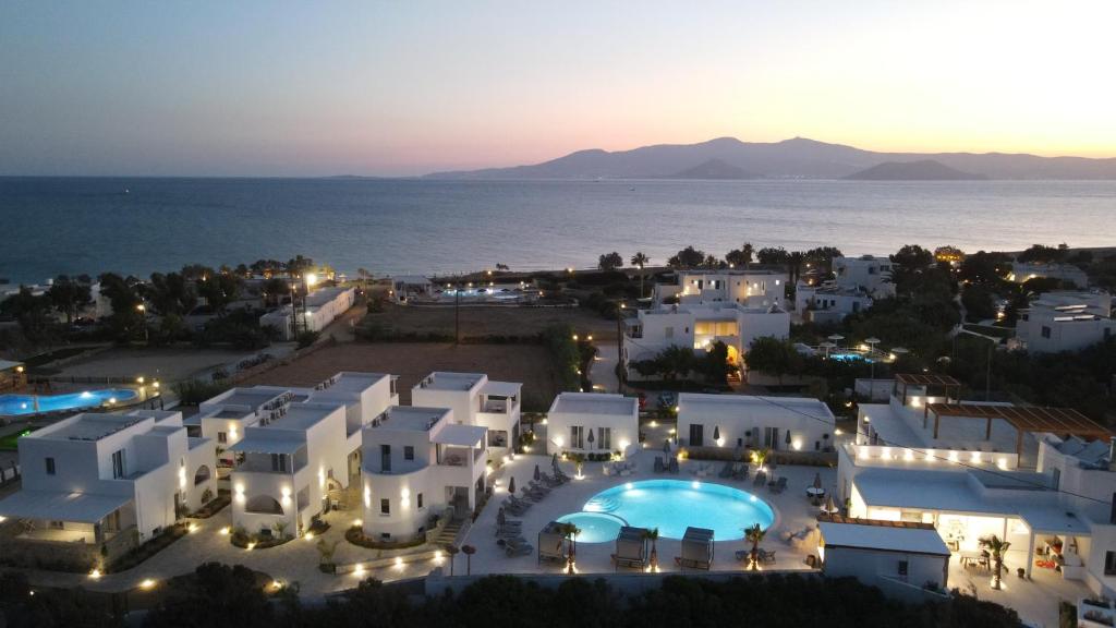 an aerial view of a villa with a pool at night at Cosmos Hotel in Plaka