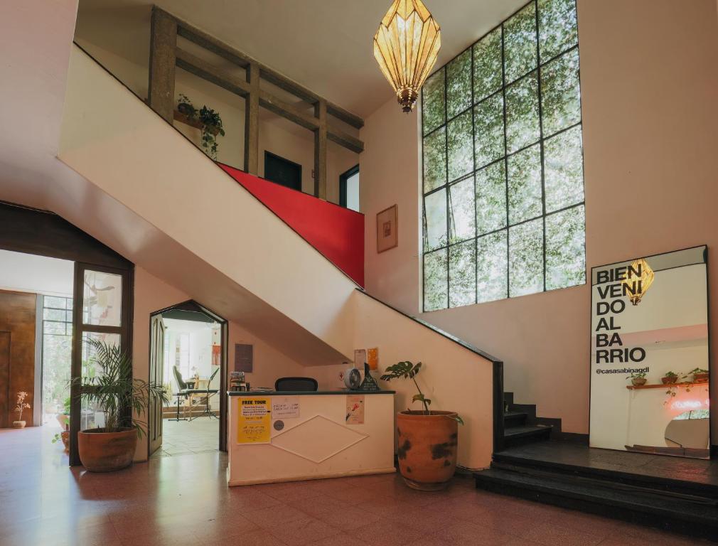 a lobby with stairs and plants in a building at Casa Sabina in Guadalajara