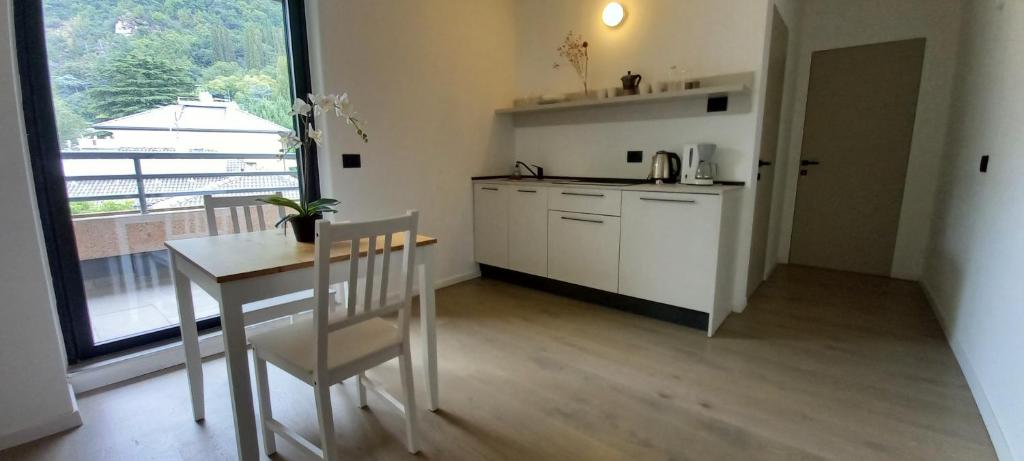 a kitchen with a table and a table and a window at Terrazza Central Apartments in Bolzano