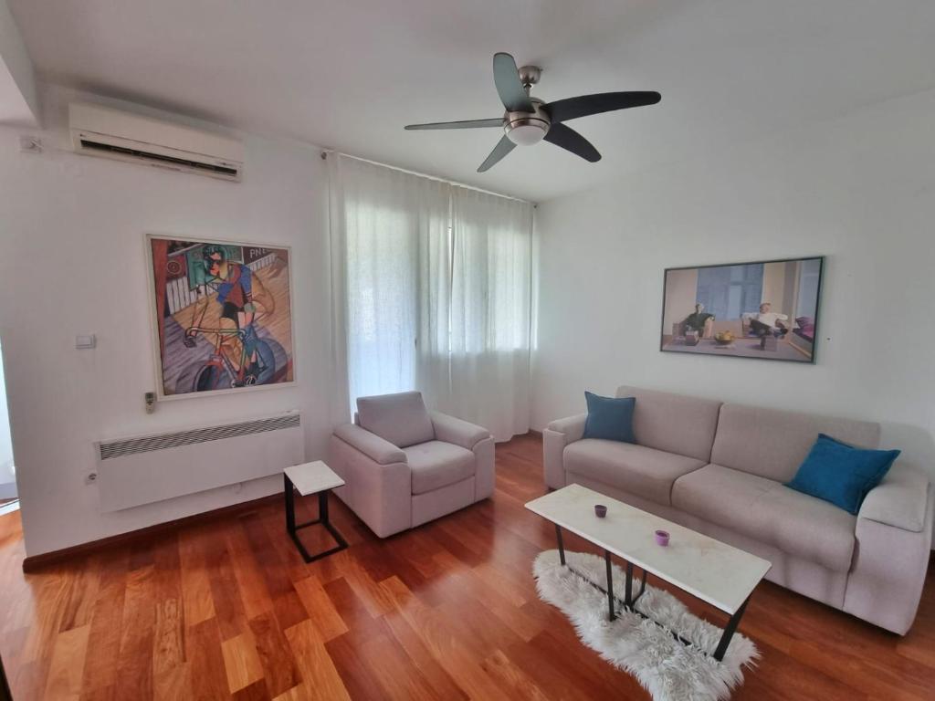 a living room with a couch and a table at Baby Blue Apartments in Bar