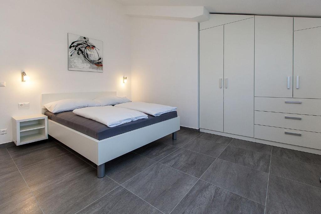 Postel nebo postele na pokoji v ubytování Villa Lilli - Appartements Kroatien