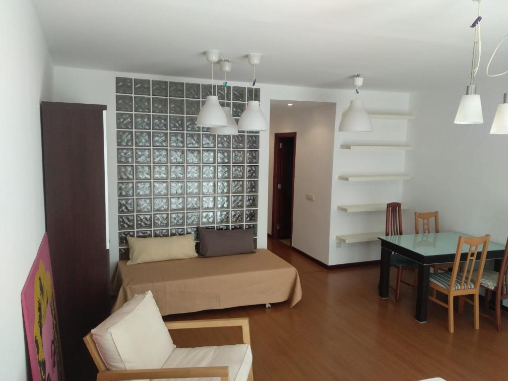 a living room with a couch and a table at Apartamentos A Casa da Herba in Redondela