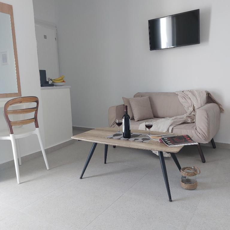a living room with a couch and a coffee table at Elite Suites Naxos in Naxos Chora