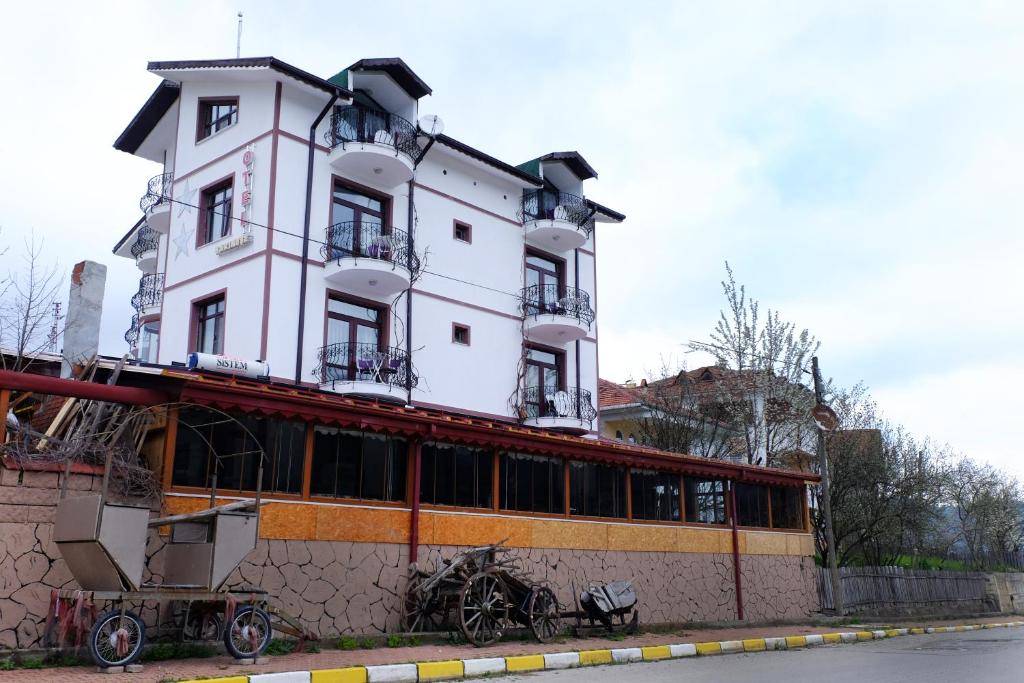 a large white building on top of a building at SARIMESE OTEL in Demirci