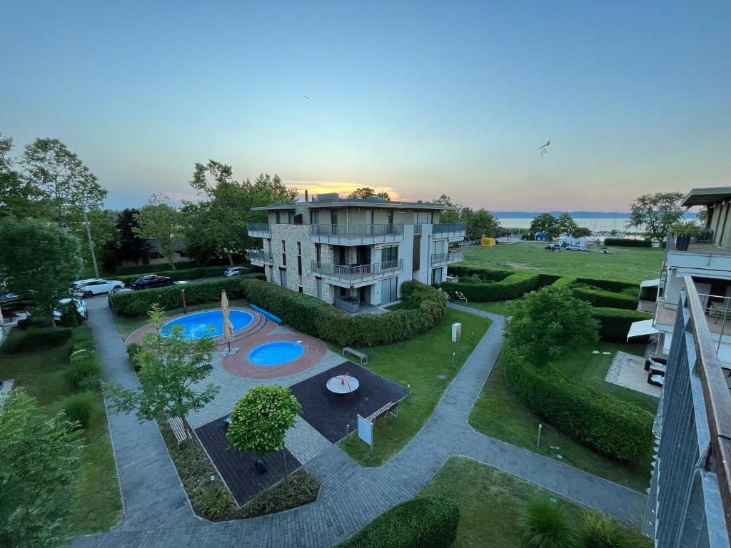 an aerial view of a building with a swimming pool at ZMRD Resort in Zamárdi